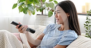 Woman watching tv at home