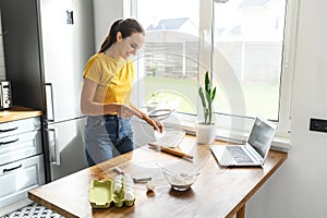 Woman is watching video recipes and cooking