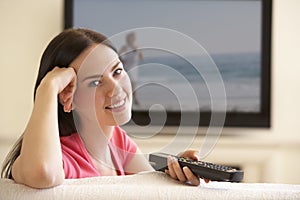 Woman Watching Widescreen TV At Home