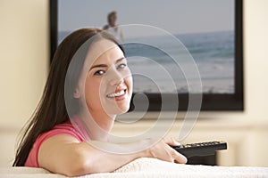 Woman Watching Widescreen TV At Home