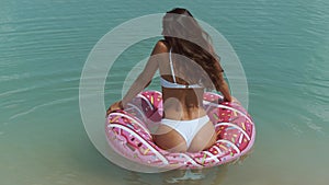 Woman in the Water with a Rubber Ring.