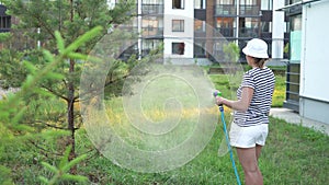 Woman watering backyard lawn