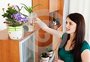 Woman watering flowers in pots