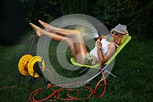 Woman watering with garden hose