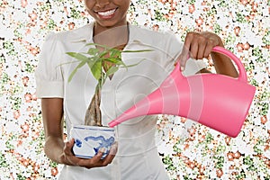 Woman watering houseplant