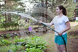 Woman watering plants in the garden