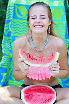 Woman with watermelon laughing sincerely