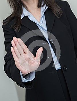 Woman waving hand and denying photo