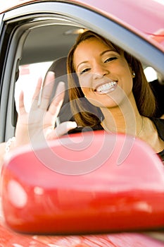 Woman waving out of car window