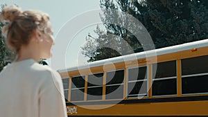 Woman waving smiling African American schoolgirl. Joyful mom saying goodbye.