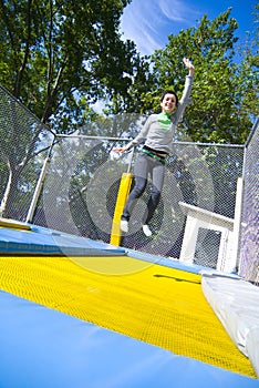 Woman waving on trampoline