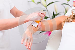 Woman at waxing hair removal in beauty parlor photo