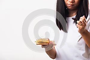 Woman weak hair her hold hairbrush with damaged long loss hair in comb brush on hand