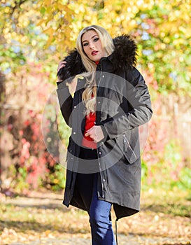 Woman wear black parka fur hood. Classic parka coat has become wardrobe icon. Versatile functional and stylish. Girl