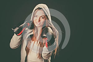 Woman wear boxer gloves with arms in air.