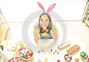 Woman wear bunny ear painted colorful Easter egg