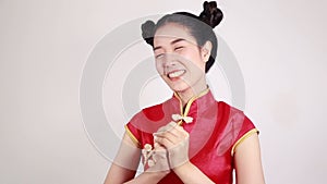 Woman wear cheongsam with gesture of congratulation in concept of happy chinese new year