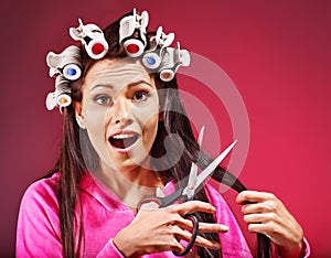 Woman wear hair curlers on head.