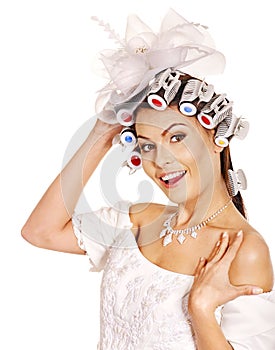 Woman wear hair curlers on head.