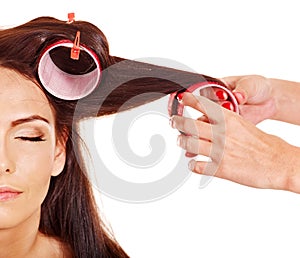 Woman wear hair curlers on head.