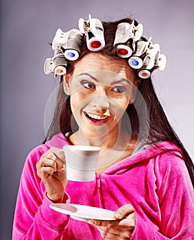 Woman wear hair curlers on head.