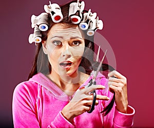 Woman wear hair curlers on head.