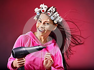 Woman wear hair curlers on head.