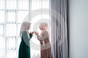 Woman wear hijab say salam when meeting her friend