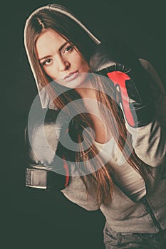 Woman wear hoodie and boxer gloves.