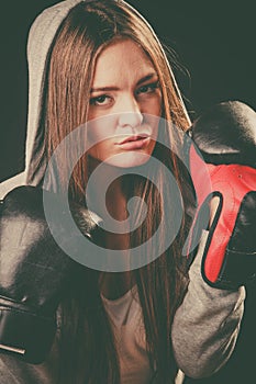 Woman wear hoodie and boxer gloves.