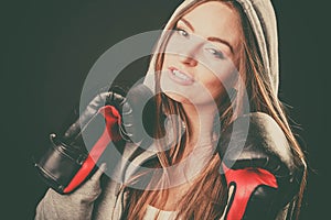 Woman wear hoodie and boxer gloves.