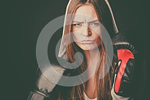 Woman wear hoodie and boxer gloves.