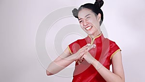 Woman wear red cheongsam with gesture of congratulation in concept of chinese new year