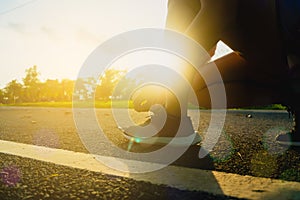 Woman wear sport shoe on to run in running court background