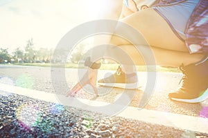 Woman wear sport shoe on to run in running court background