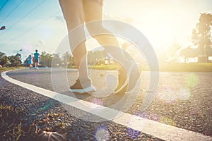 Woman wear sport shoe on to run in running court background