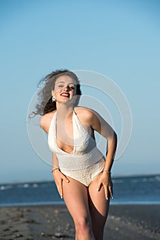 Woman wear white monokini at the beach