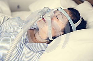 A woman wearing anti-snoring chin straps photo