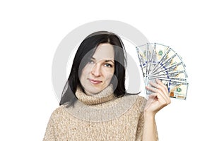 Woman wearing beige sweater holding money