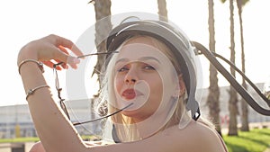 Woman wearing biking helmet. Close-up portrait of female cyclist in park.