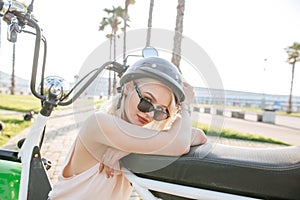 Woman wearing biking helmet. Close-up portrait of female cyclist in park.