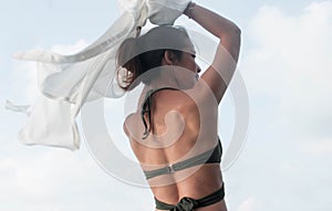 Woman wearing bikini and standing beside the sea