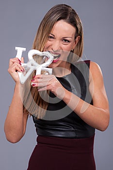 Woman wearing black dress holding sign love symbol