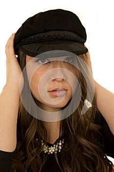 Woman wearing black hat with a somber look