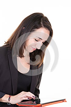 Woman wearing black suit using a tablet computer isolated on a white background