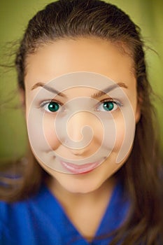 Woman wearing blue blouse with malicious smile