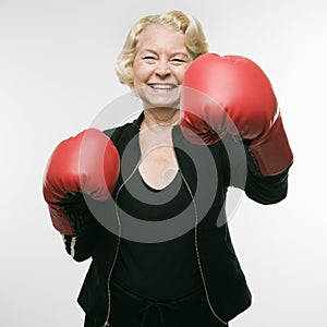 Woman wearing boxing gloves.