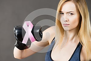 Woman wearing boxing gloves having pink ribbon