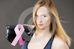 Woman wearing boxing gloves having pink ribbon