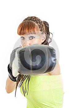 woman wearing boxing gloves ready to fight and punching or hitting camera or you